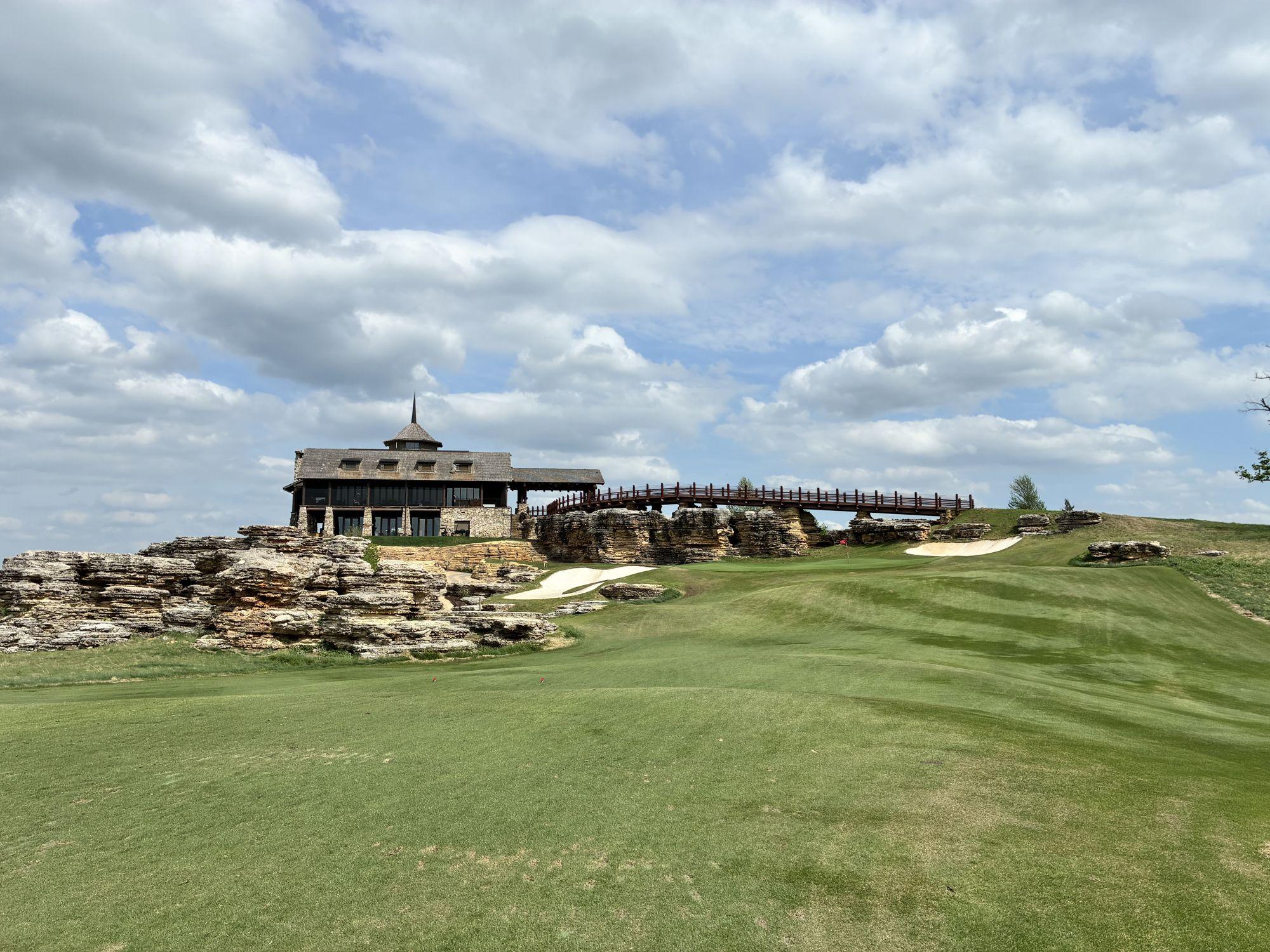 The timber-and-stone clubhouse and arch bridge above a sweeping fairway at Top of the Rock golf course near Branson, Missouri