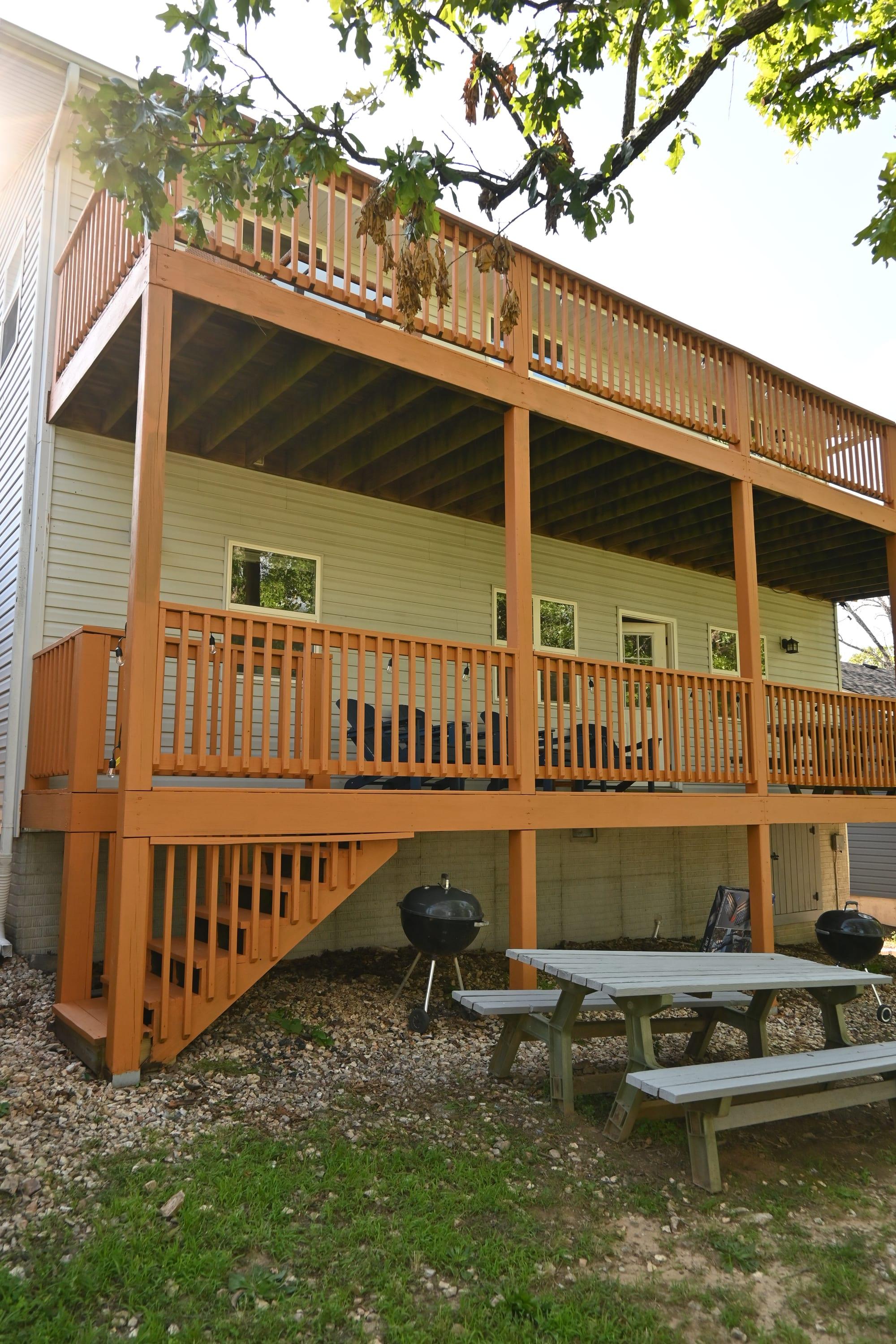 Back of the property showing the two-level covered decks and picnic area