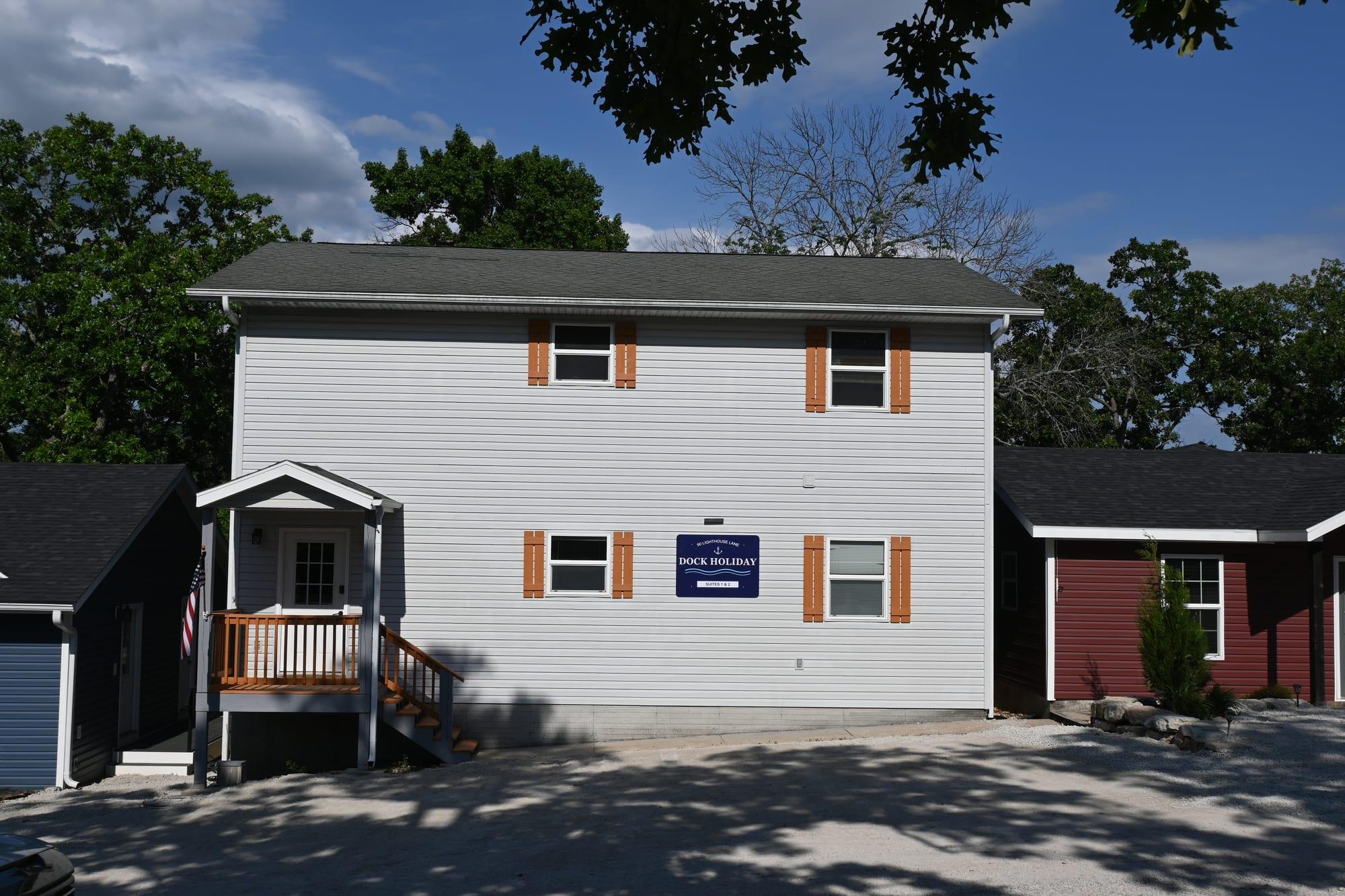 Angled front view of the two-story Dock Holiday Suites building