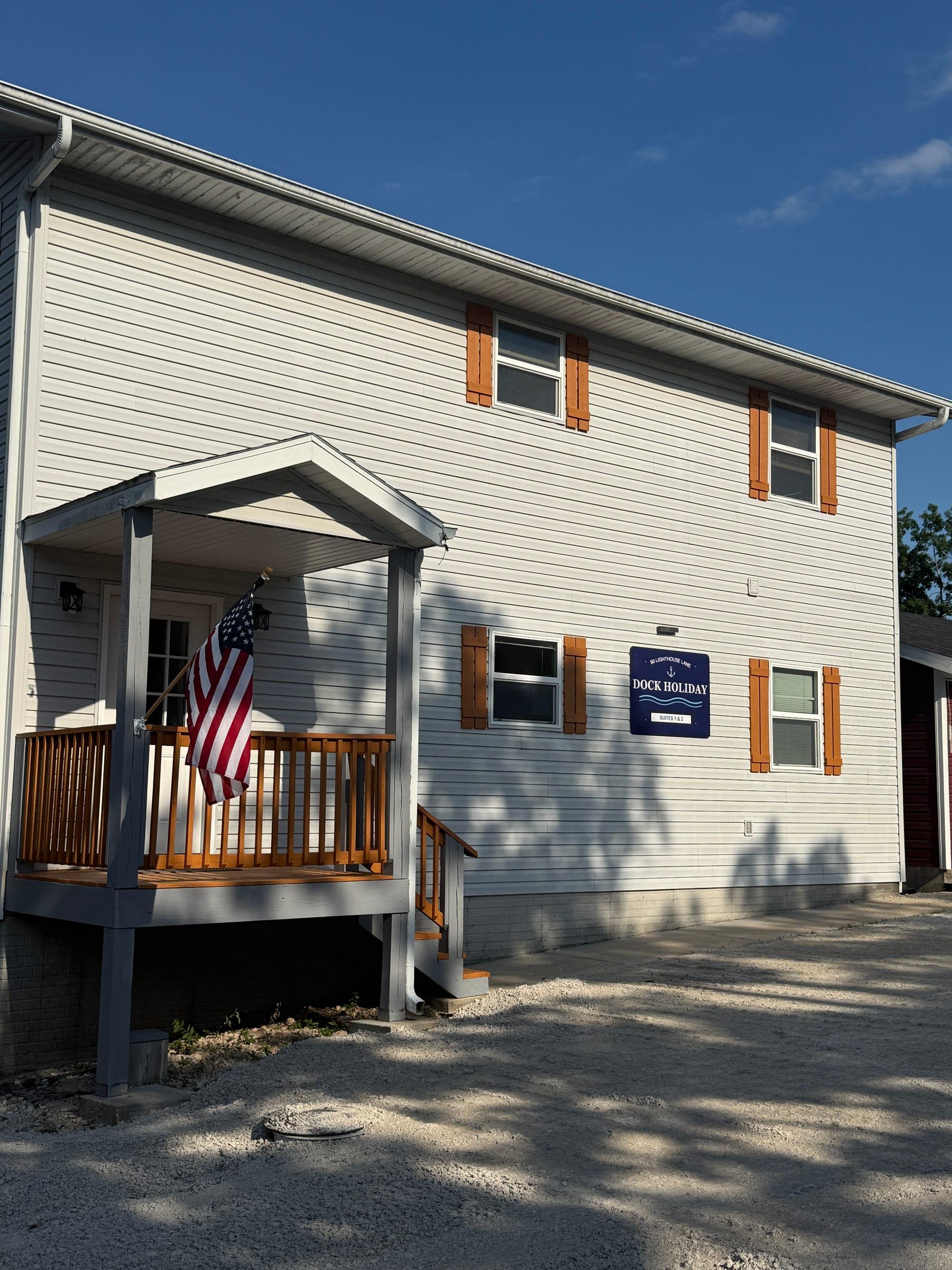Front entrance of Dock Holiday Suites with deck seating