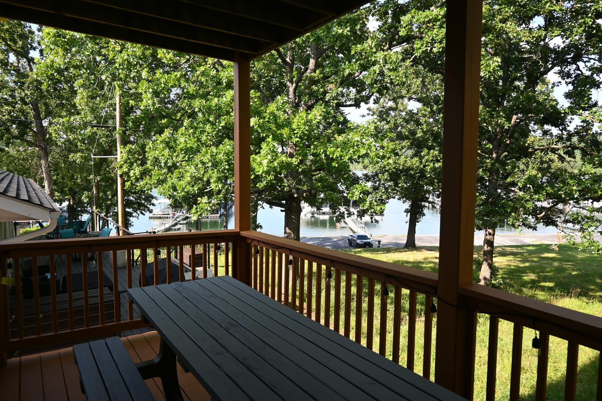 Covered deck of Suite 1 with a view through the trees to Table Rock Lake