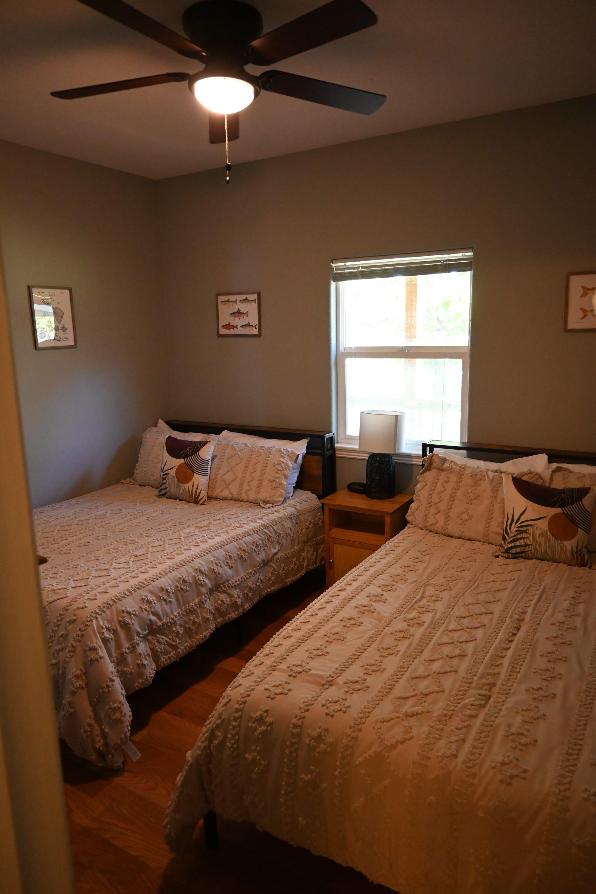Bright second bedroom with two queen beds in Suite 1